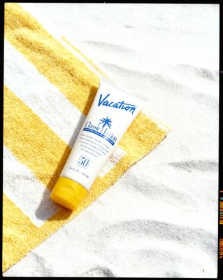 a tube of sunscreen sitting on a towel