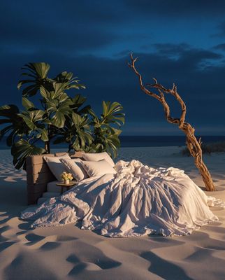 a bed sitting on top of a sandy beach
