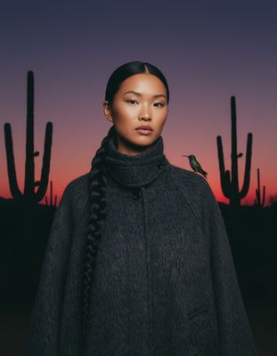 a woman with a bird on her shoulder