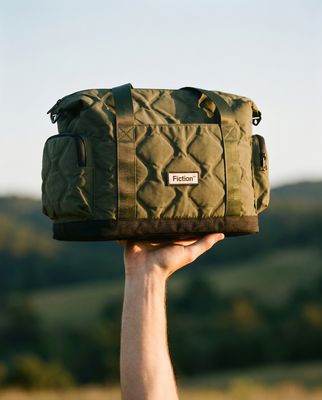 a person holding a green bag in the air