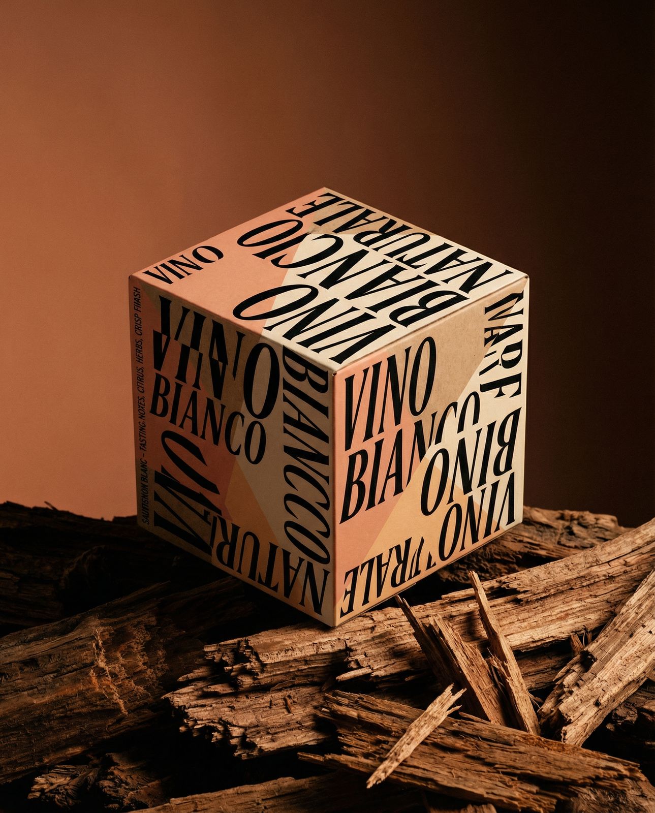 a box of wine sitting on top of a pile of wood