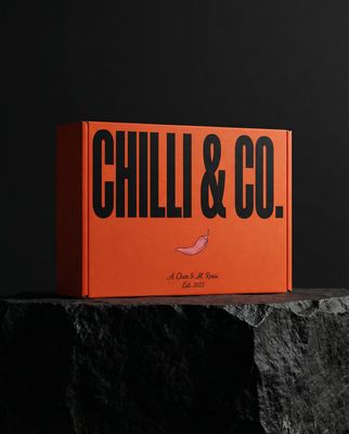 a box of chilli and co sitting on a rock