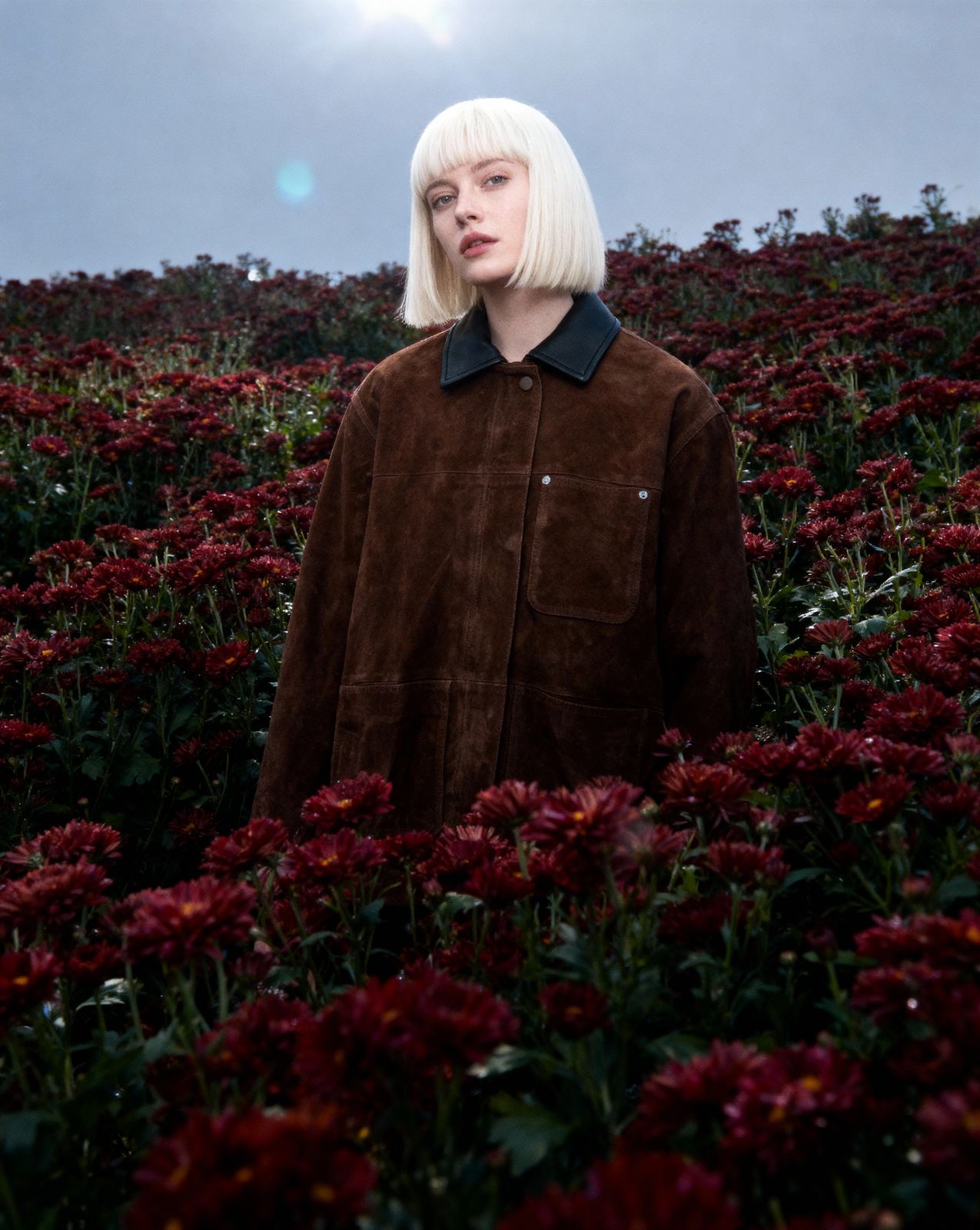 a woman standing in a field of flowers