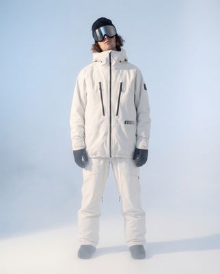 a man in a white snow suit and goggles