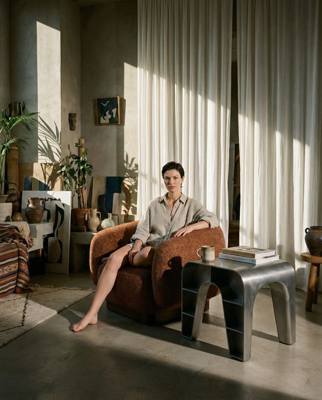 a woman sitting on a chair in a living room