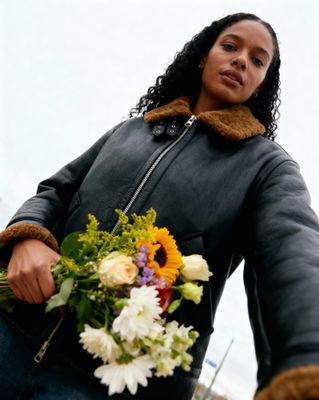 a woman holding a bouquet of flowers in her hands