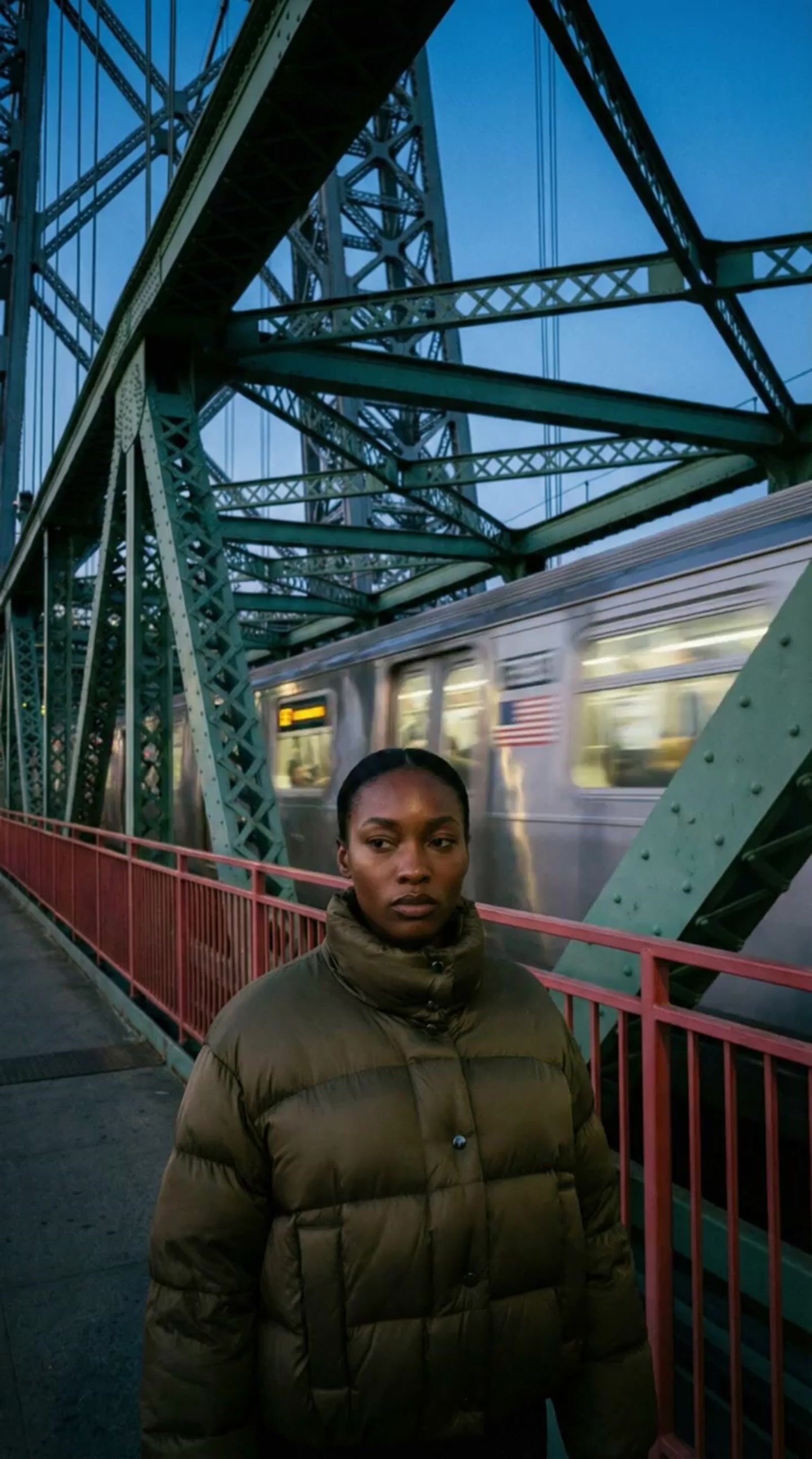 a man standing on a bridge next to a train