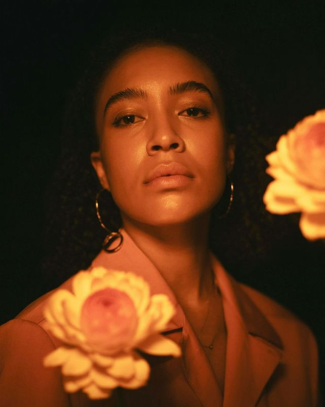 a woman with a flower in her hand