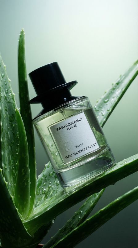 a bottle of perfume sitting on top of a plant