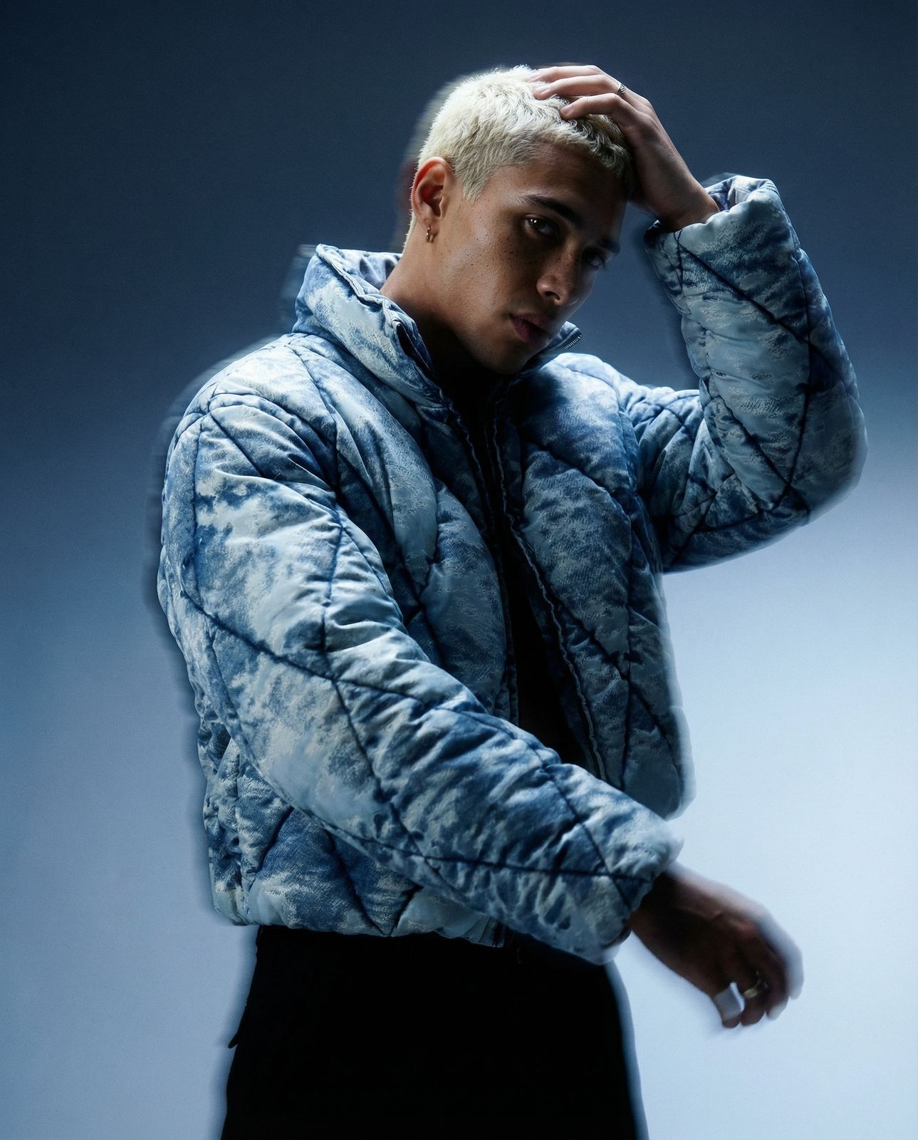 a man in a blue jacket and black pants