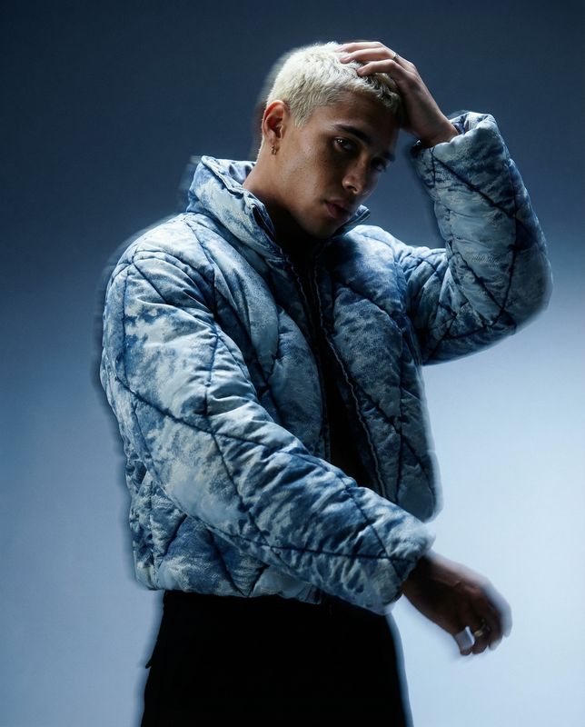 a man in a blue jacket and black pants