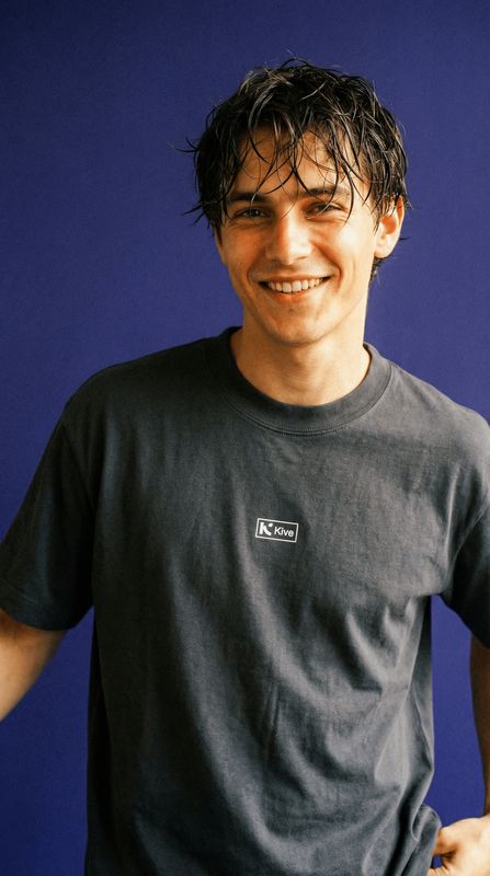 a man with wet hair is smiling for the camera