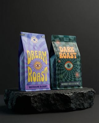 two bags of coffee sitting on top of a rock