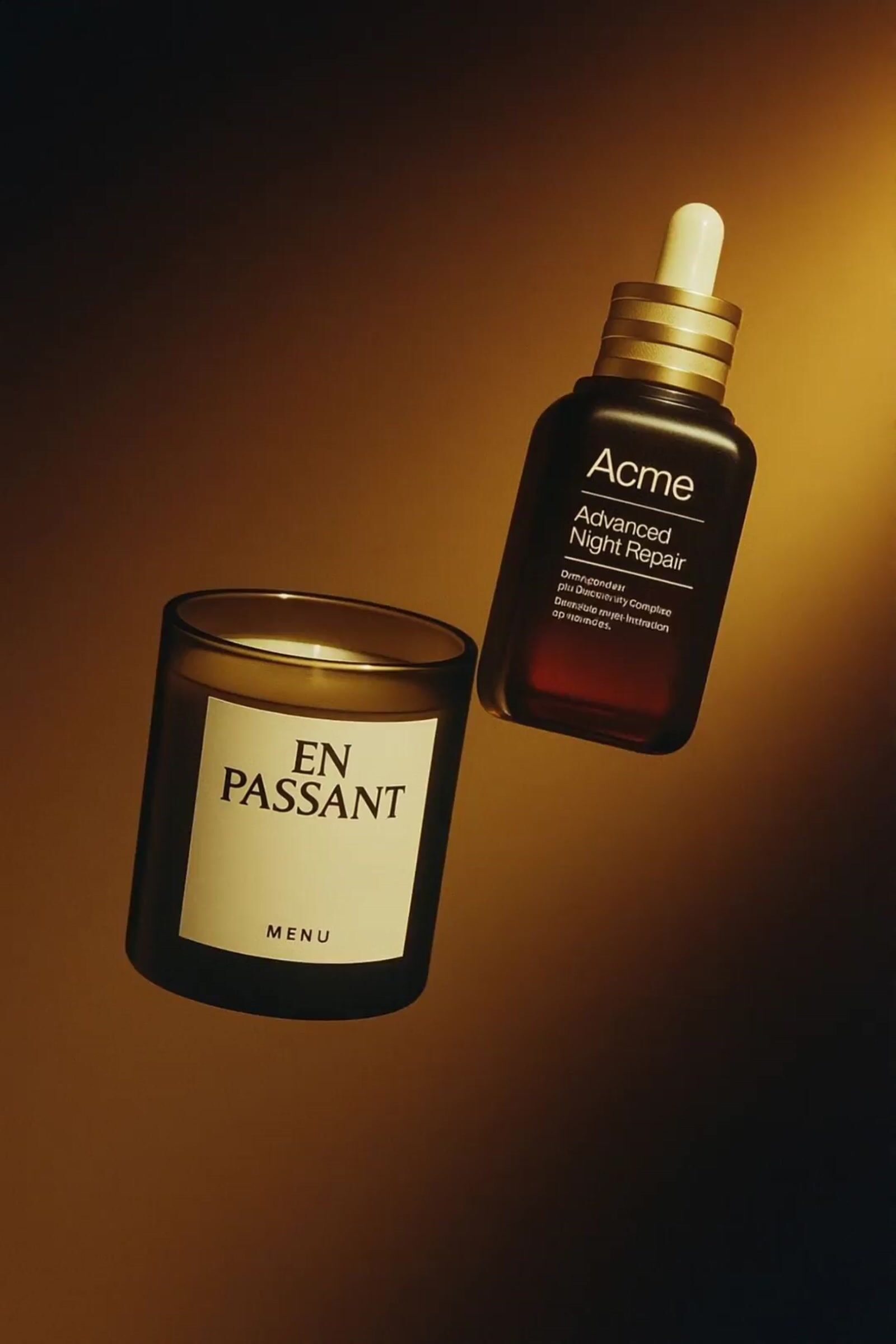 a bottle of acne next to a candle