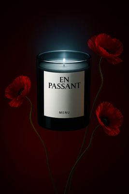 a candle that is sitting next to some flowers
