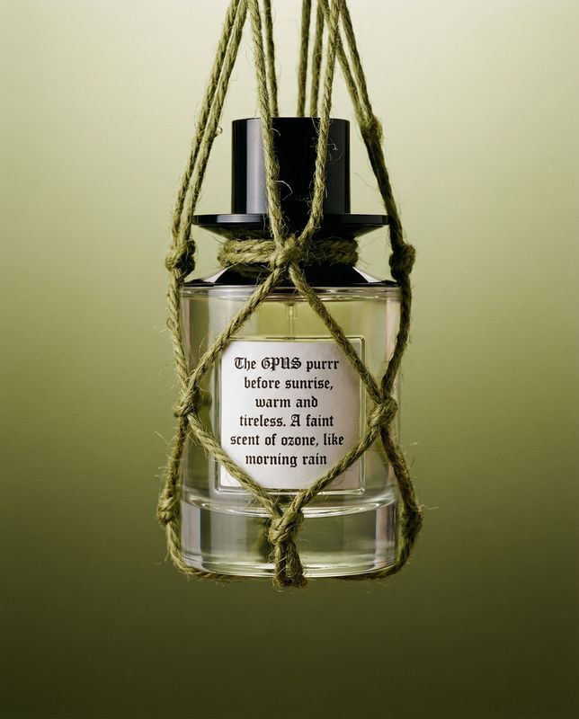 a bottle of perfume hanging from a rope