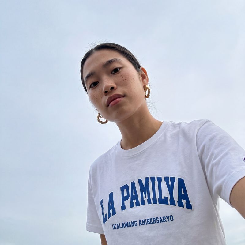 a woman holding a frisbee in her right hand