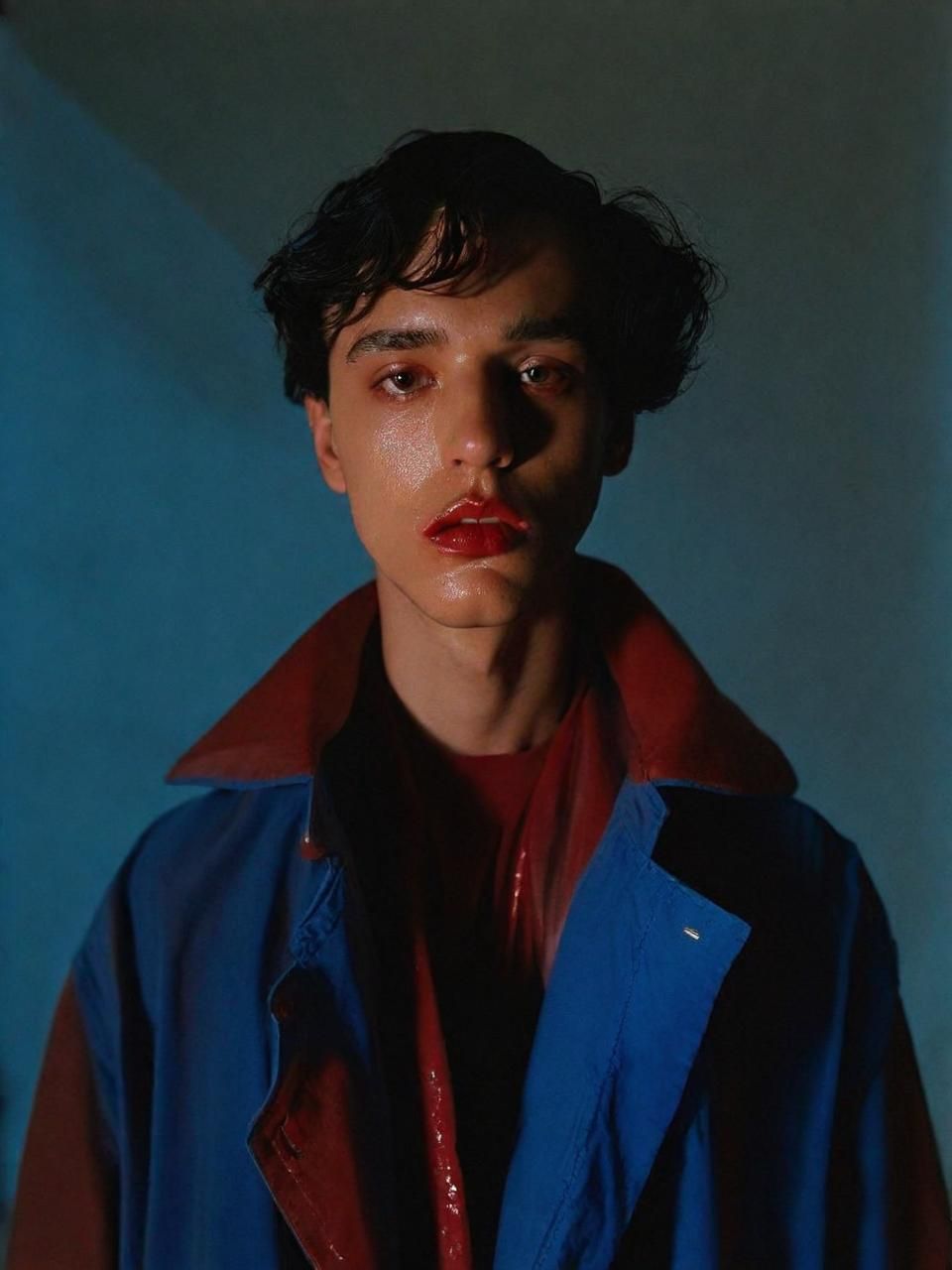 a man with a red lip and a blue jacket