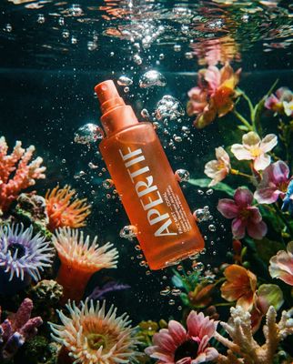 an orange bottle floating on top of a body of water