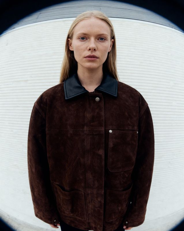 a woman standing in front of a circular object