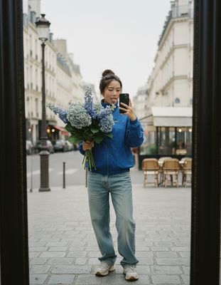 a woman taking a picture of herself in a mirror