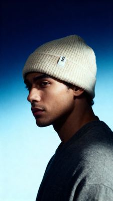 a young man wearing a beanie looking at the camera