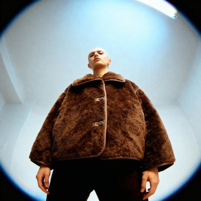 a man standing in front of a round object