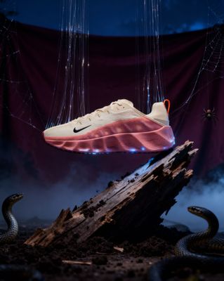 a pair of nike shoes hanging from a string