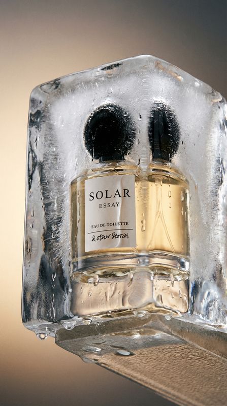 a couple of bottles of perfume sitting on top of a shelf