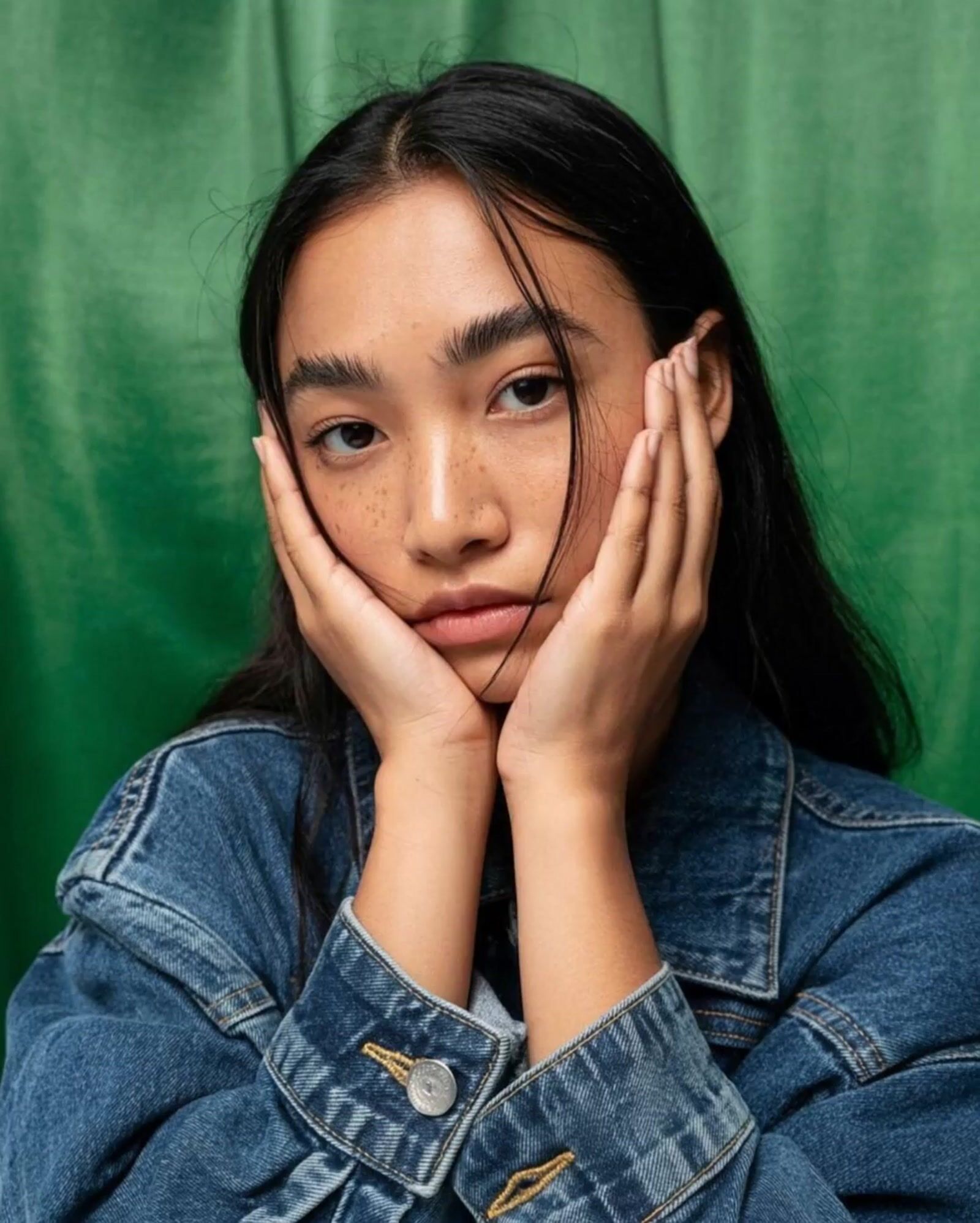 a woman with her hands on her face