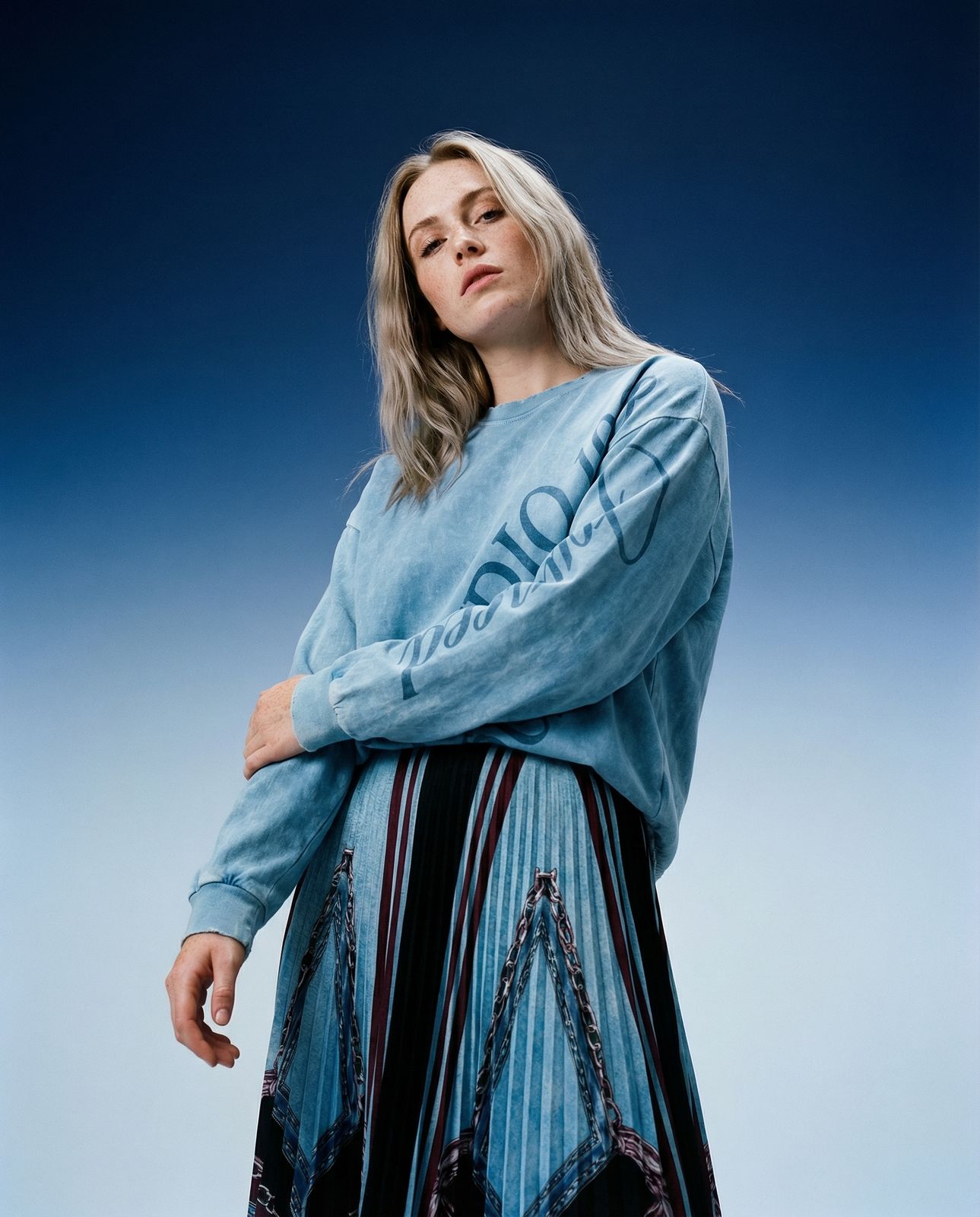 a woman in a blue shirt and black skirt