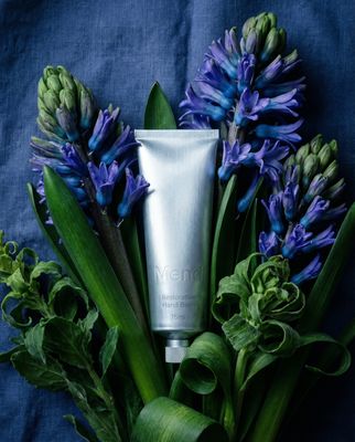 a tube of lotion sitting on top of a bouquet of flowers