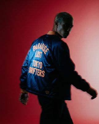 a man in a blue jacket with words on it