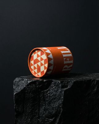 a cup sitting on top of a rock