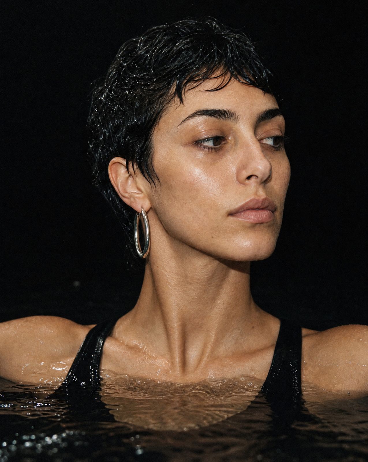 a woman in a black tank top in the water