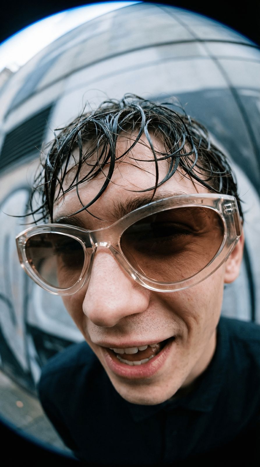 a man wearing sunglasses and a black shirt