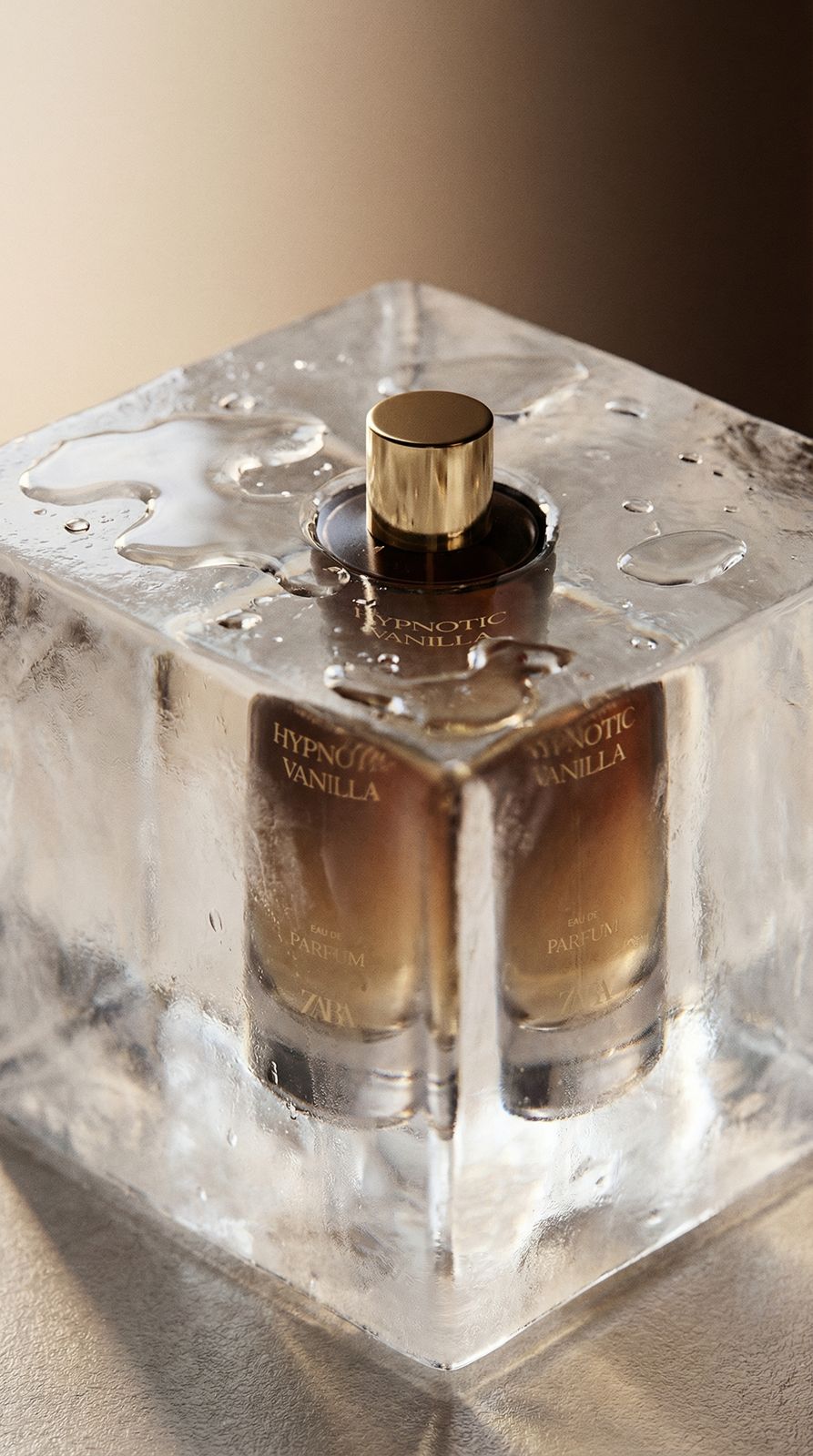 a couple of bottles of perfume sitting on top of a block of ice