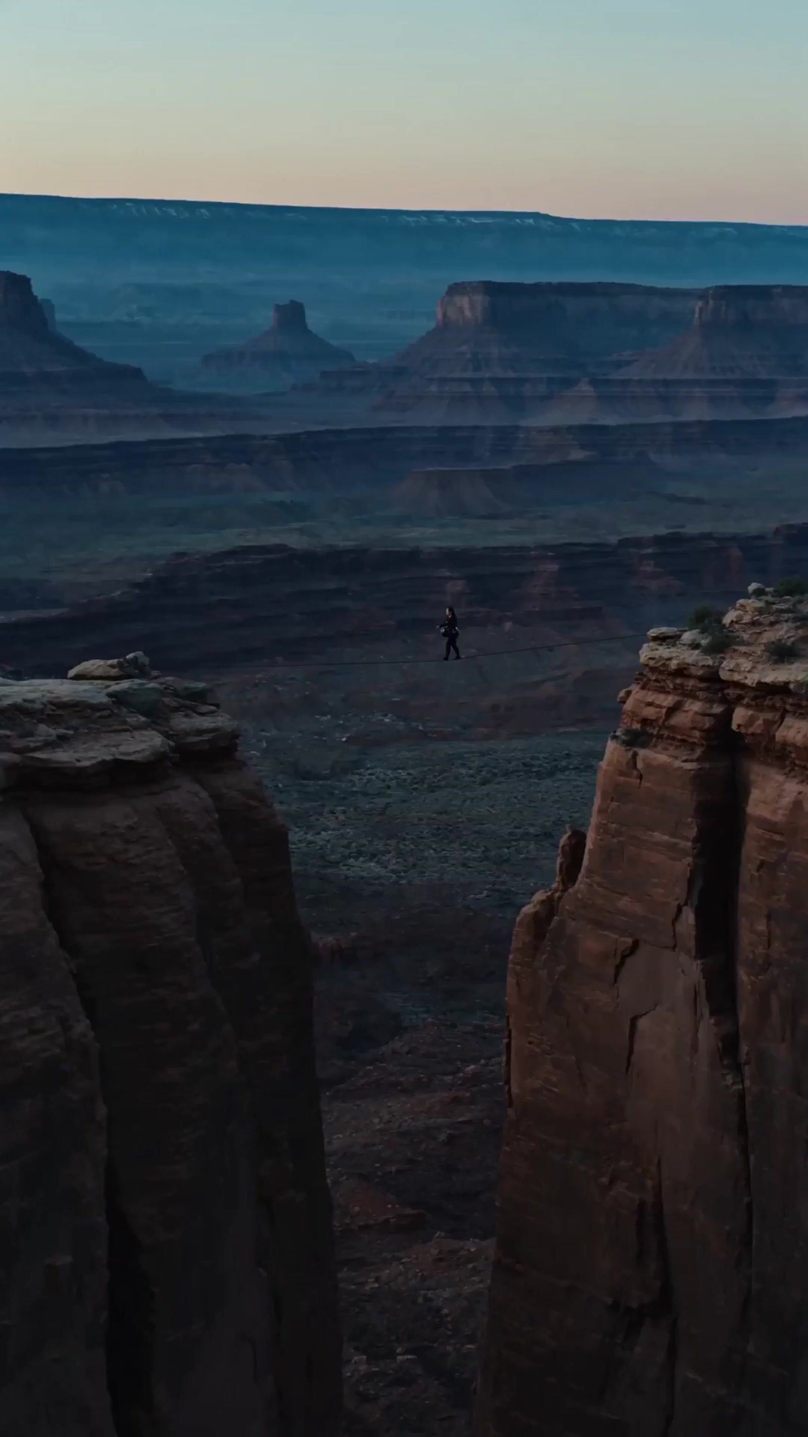 a person standing on top of a cliff