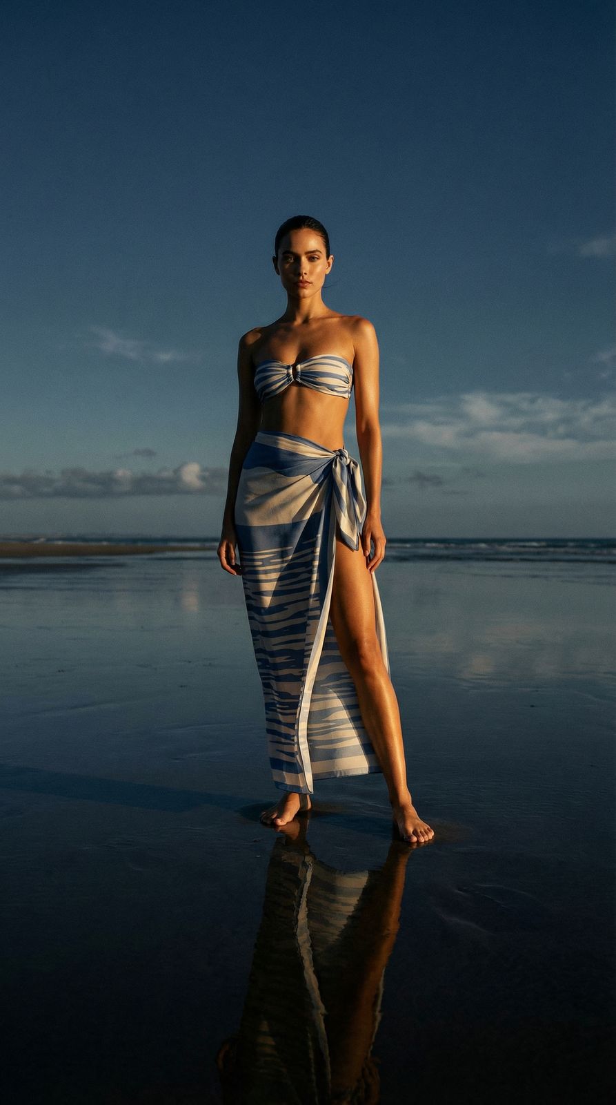 a woman standing on a beach next to the ocean