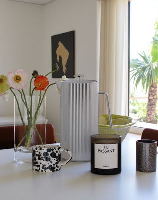 a white table topped with vases filled with flowers
