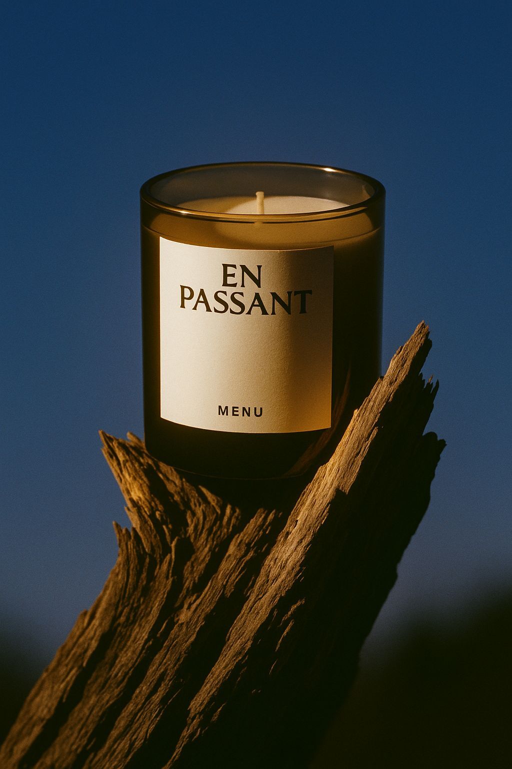 a candle sitting on top of a piece of wood