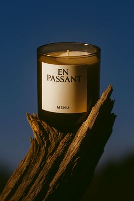 a candle sitting on top of a piece of wood