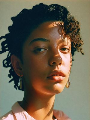 a close up of a person with curly hair