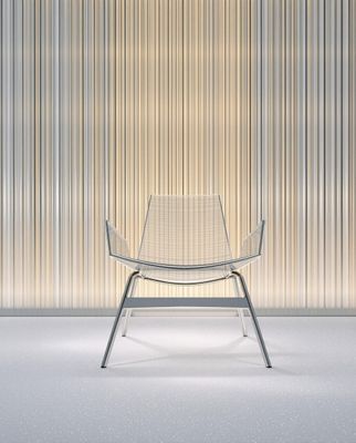 a white chair sitting in front of a wall