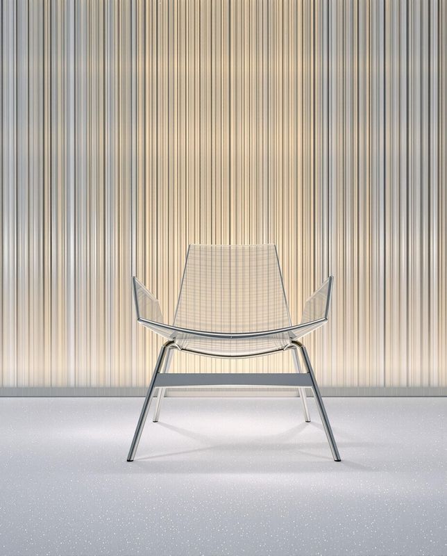 a white chair sitting in front of a wall