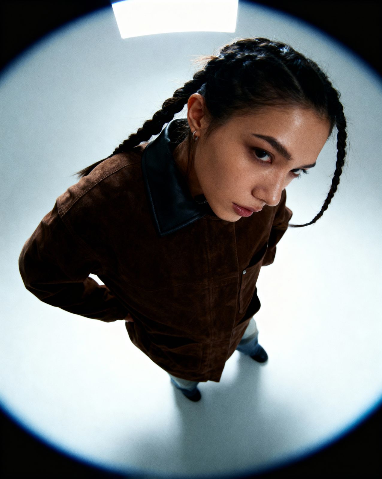 a woman with braids standing in front of a camera