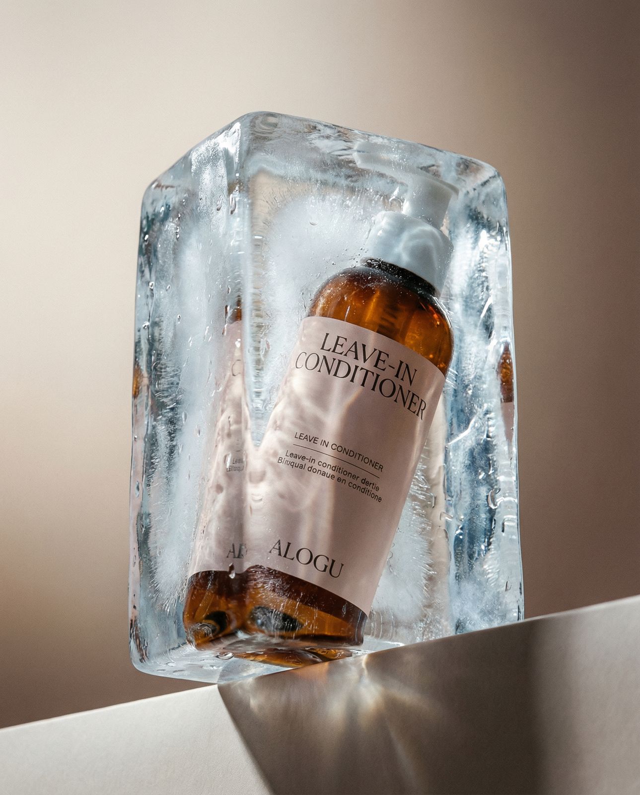 a bottle of leave - on conditioner sitting on an ice block