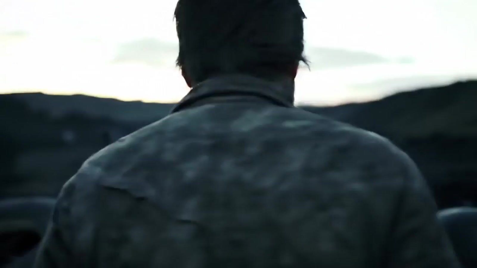 a man standing in front of a mountain with a cell phone in his hand