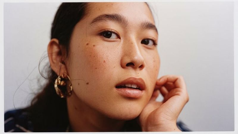 a close up of a person with a earring