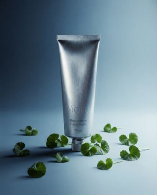 a tube of toothpaste surrounded by leaves